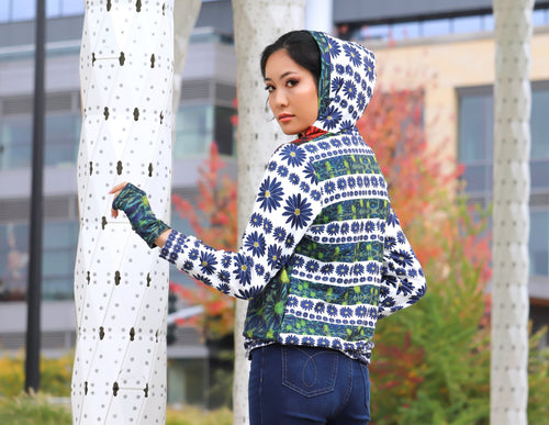 A Peruvian female model showing the back of the Floral Muse Hooded Graphic Jacket | Peruvian Graphic Jacket