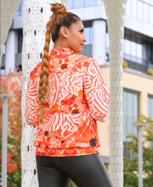 A Peruvian female model showing the back of the Sunset Petals Collared Graphic Jacket | Peruvian Graphic Jacket